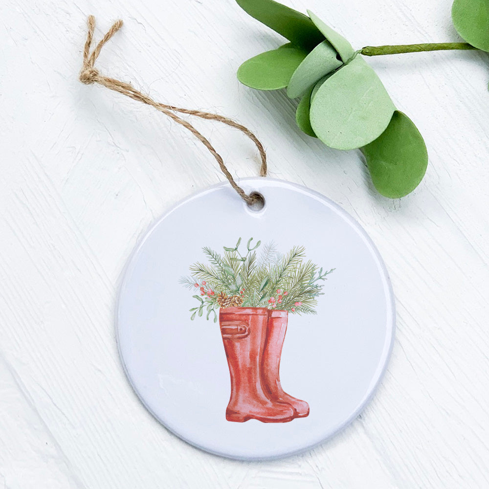 A beautifully crafted porcelain ornament featuring winter rain boots and foliage design, perfect for holiday decor or as a gift tag.