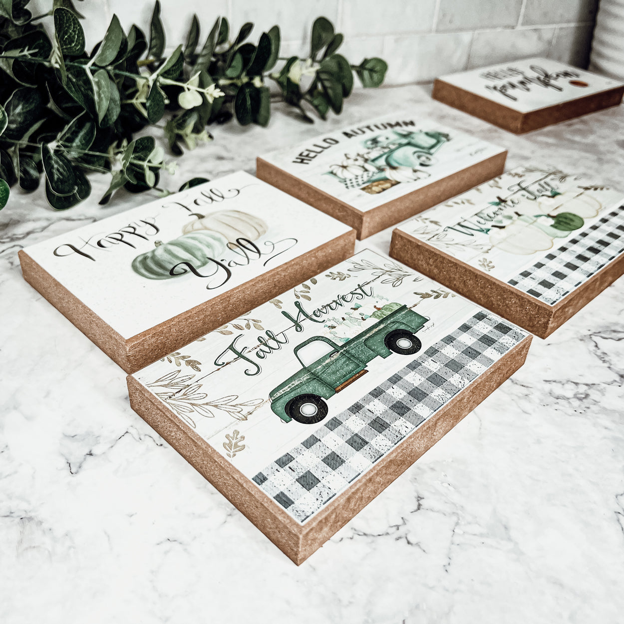 A rustic Fall Harvest sign made of thick wood, featuring autumn-themed designs, perfect for home decor during fall and Halloween.