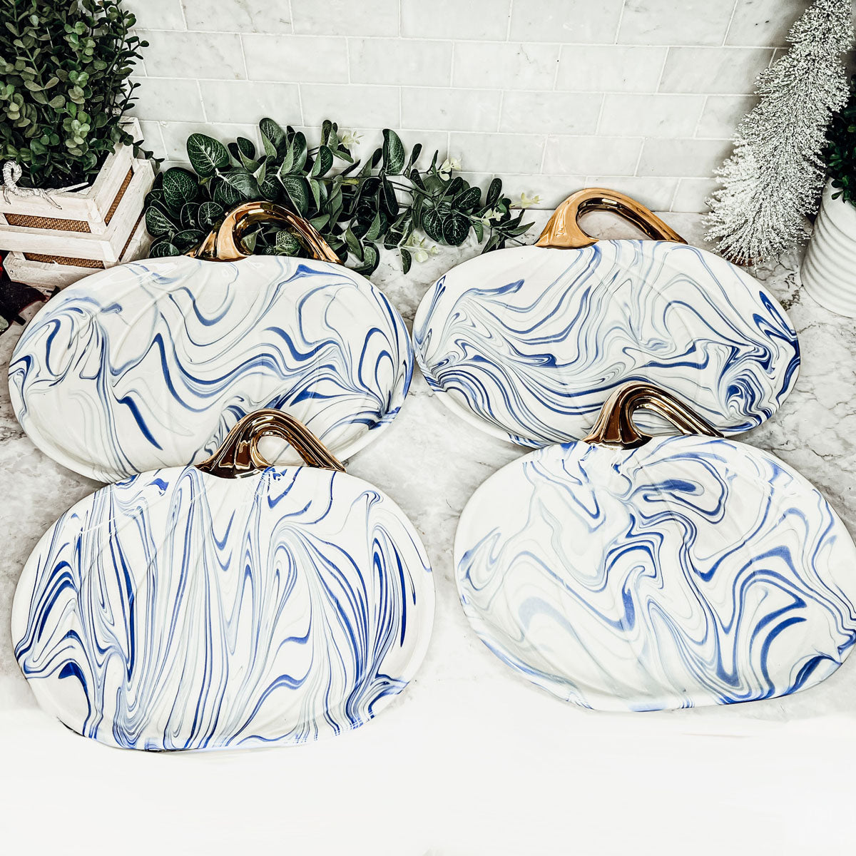 Martha Blue Pumpkin Plate set featuring marbled blue and white design with elegant gold stems, perfect for serving desserts.