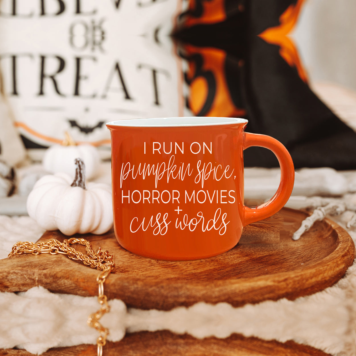 Pumpkin + Horror Mug featuring vibrant orange color and white lettering, perfect for fall and horror movie lovers.