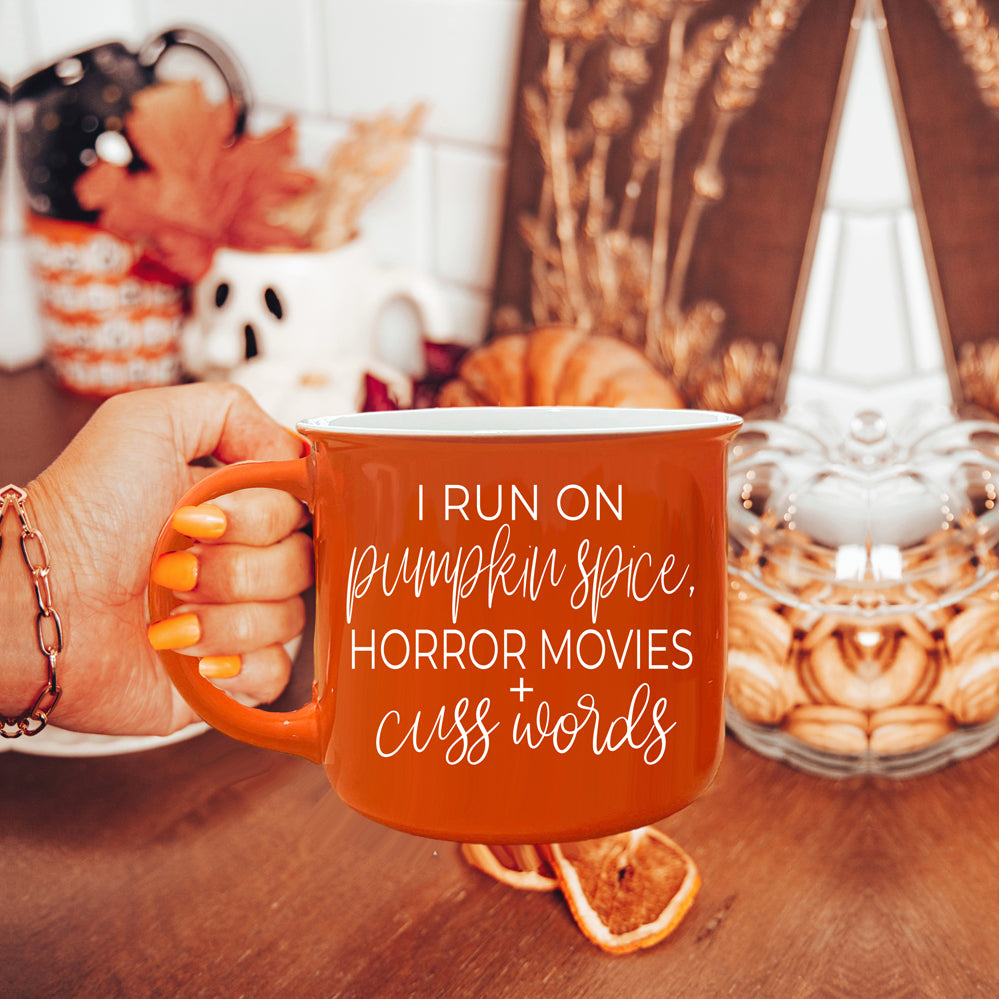 Pumpkin + Horror Mug featuring vibrant orange color and white lettering, perfect for fall and horror movie lovers.