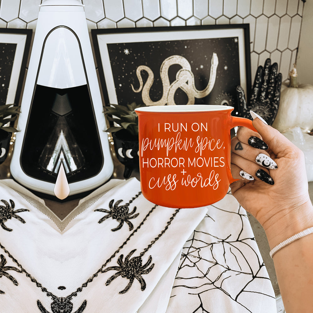 Pumpkin + Horror Mug featuring vibrant orange color and white lettering, perfect for fall and horror movie lovers.