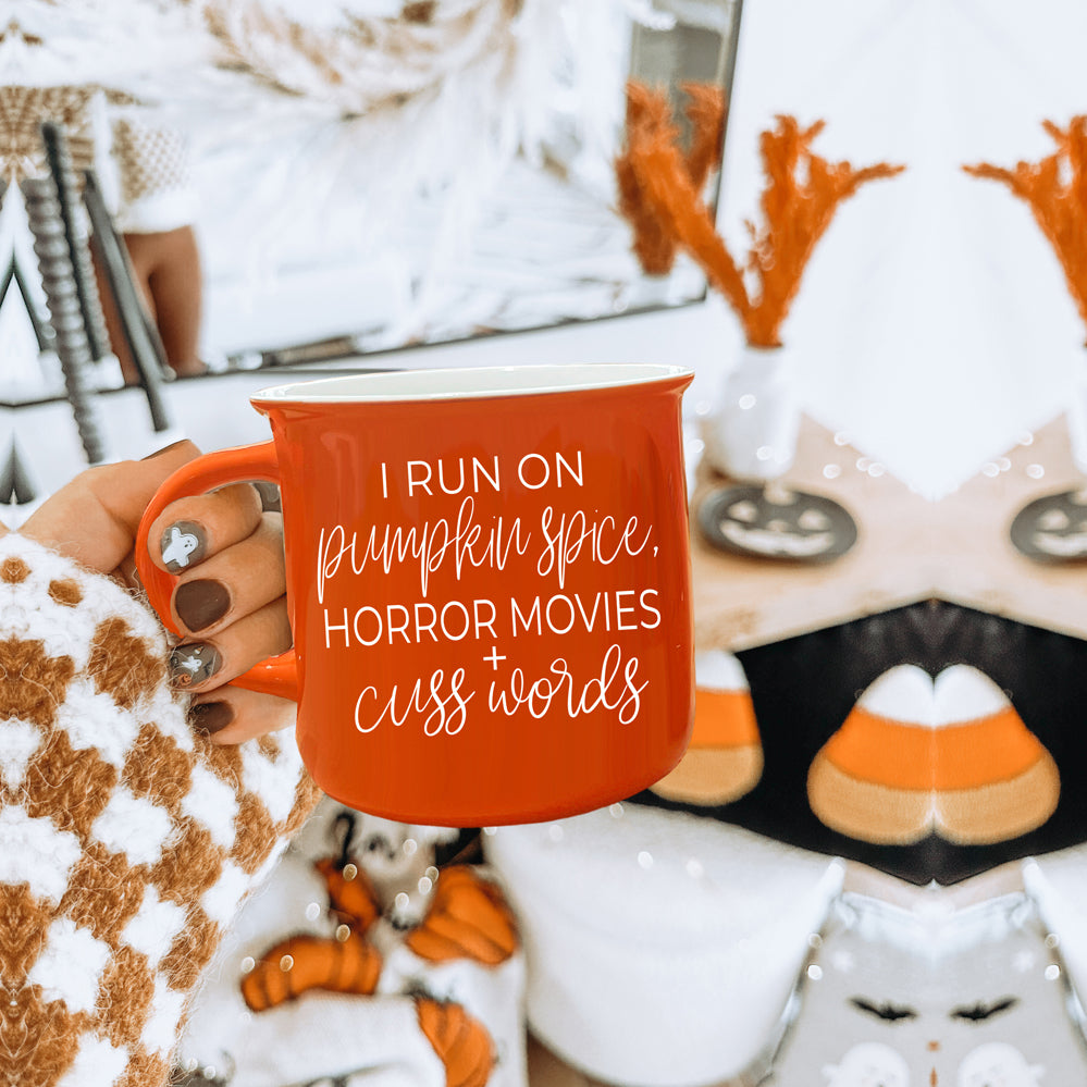 Pumpkin + Horror Mug featuring vibrant orange color and white lettering, perfect for fall and horror movie lovers.