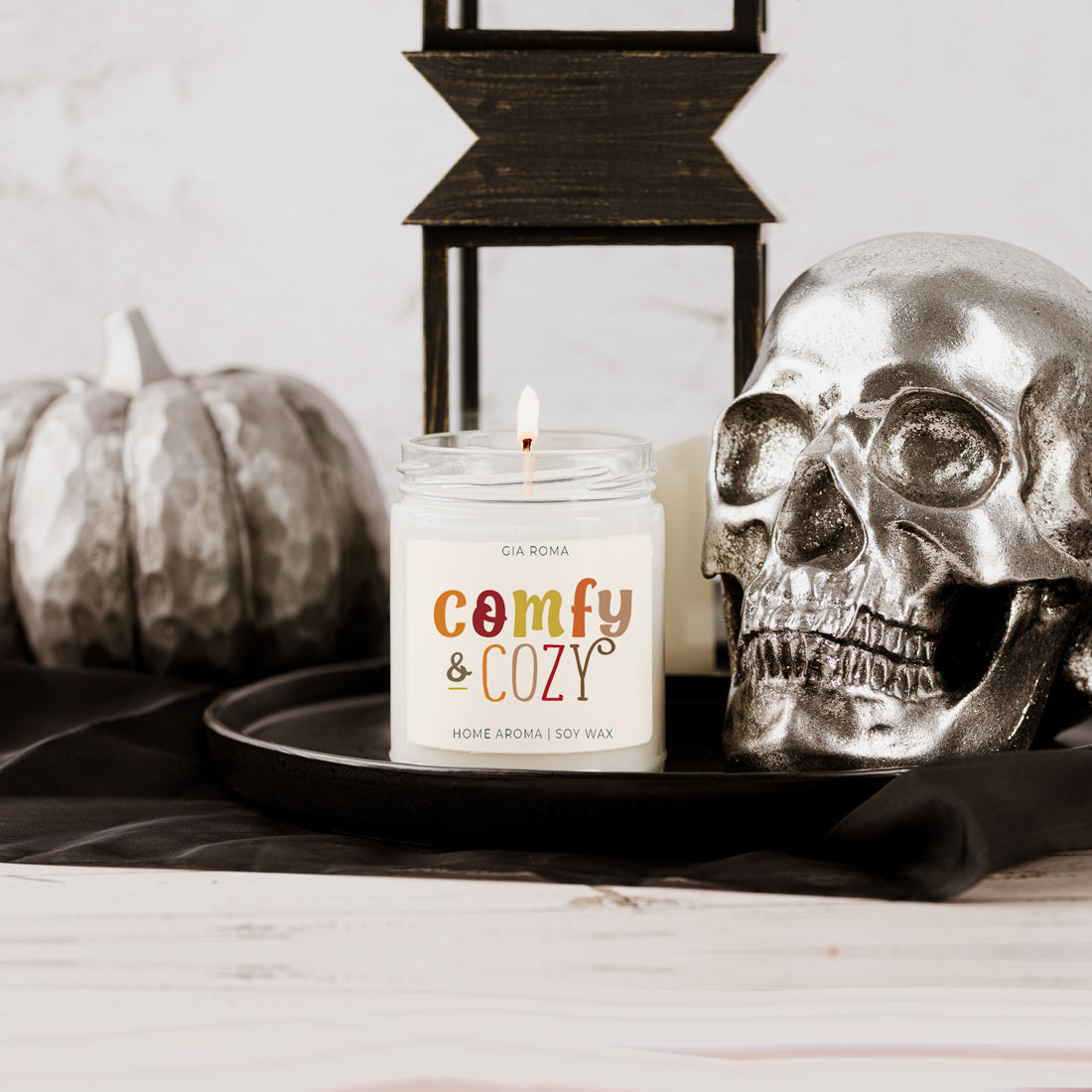 Candle with skull and pumpkin.
