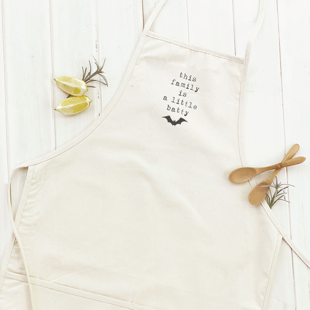 A stylish women's apron featuring a fun batty design, made from durable cotton canvas with adjustable neck and twill ties.