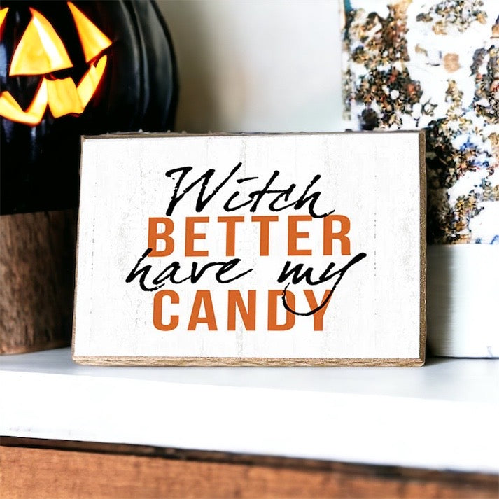 A rustic wooden sign reading 'Witch Better Have My Candy' in black and orange lettering, perfect for Halloween decor.