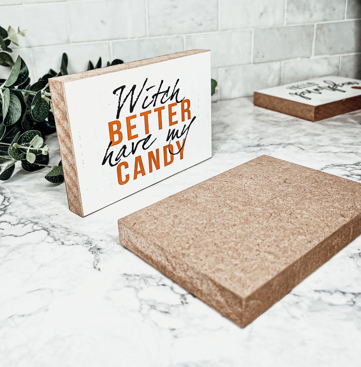 A rustic wooden sign reading 'Witch Better Have My Candy' in black and orange lettering, perfect for Halloween decor.