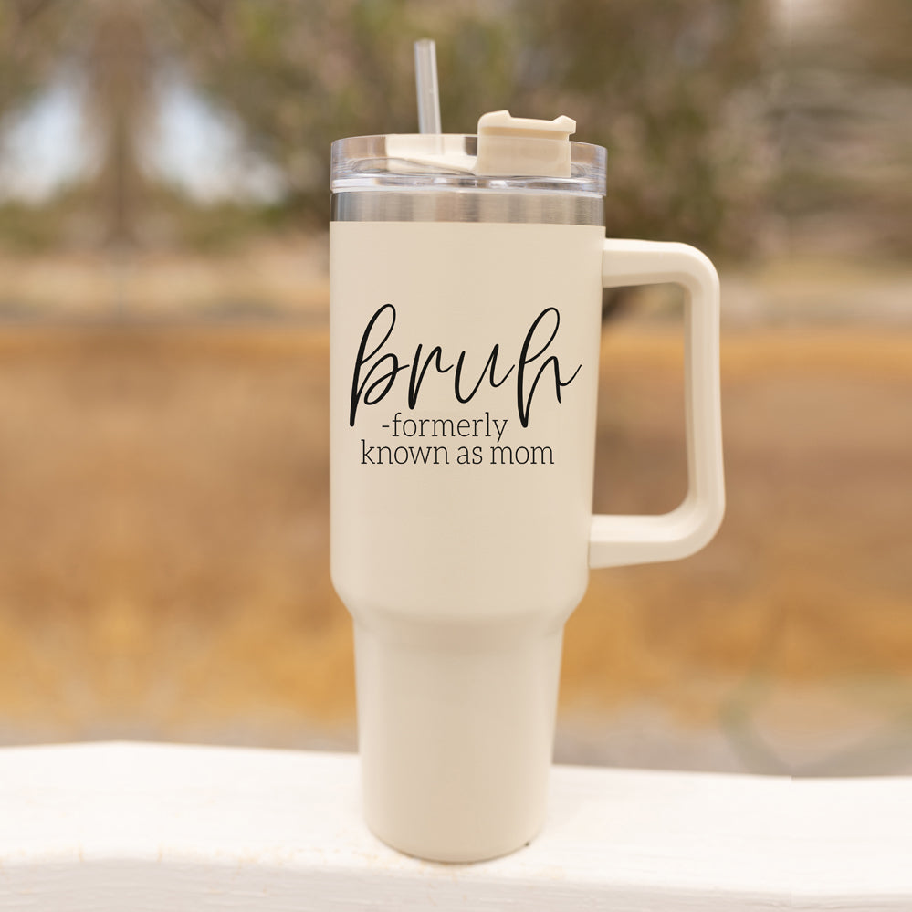 Bruh 40oz tumbler with cream exterior and black graphic design, featuring a handle and a versatile 3-in-1 lid.