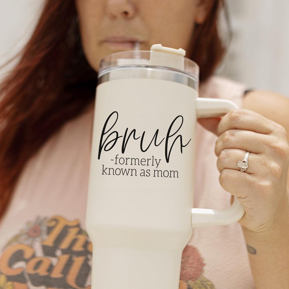 Bruh 40oz tumbler with cream exterior and black graphic design, featuring a handle and a versatile 3-in-1 lid.