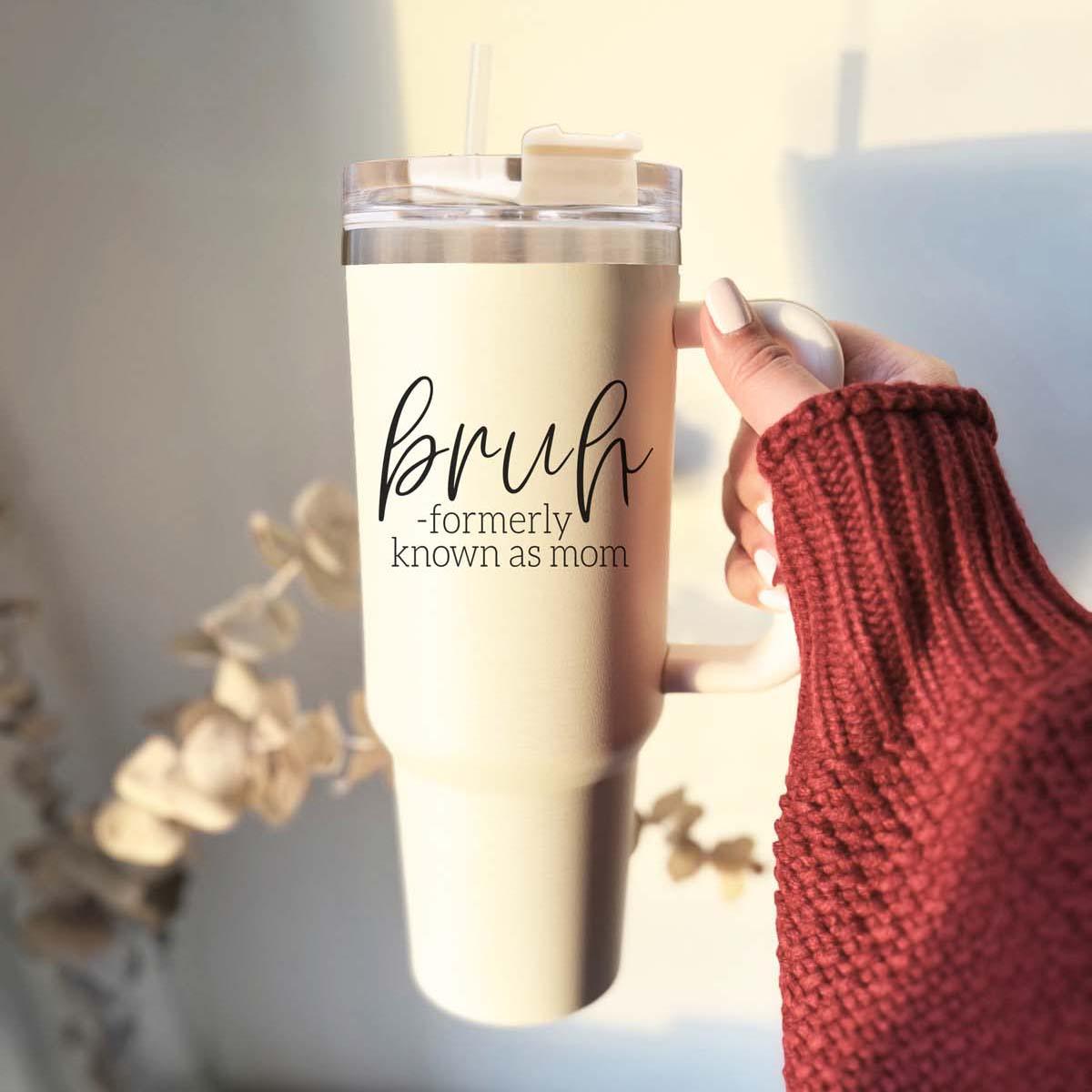 Bruh 40oz tumbler with cream exterior and black graphic design, featuring a handle and a versatile 3-in-1 lid.