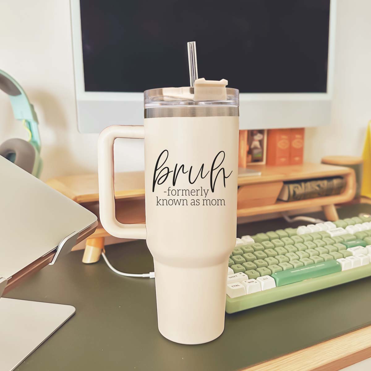 Bruh 40oz tumbler with cream exterior and black graphic design, featuring a handle and a versatile 3-in-1 lid.