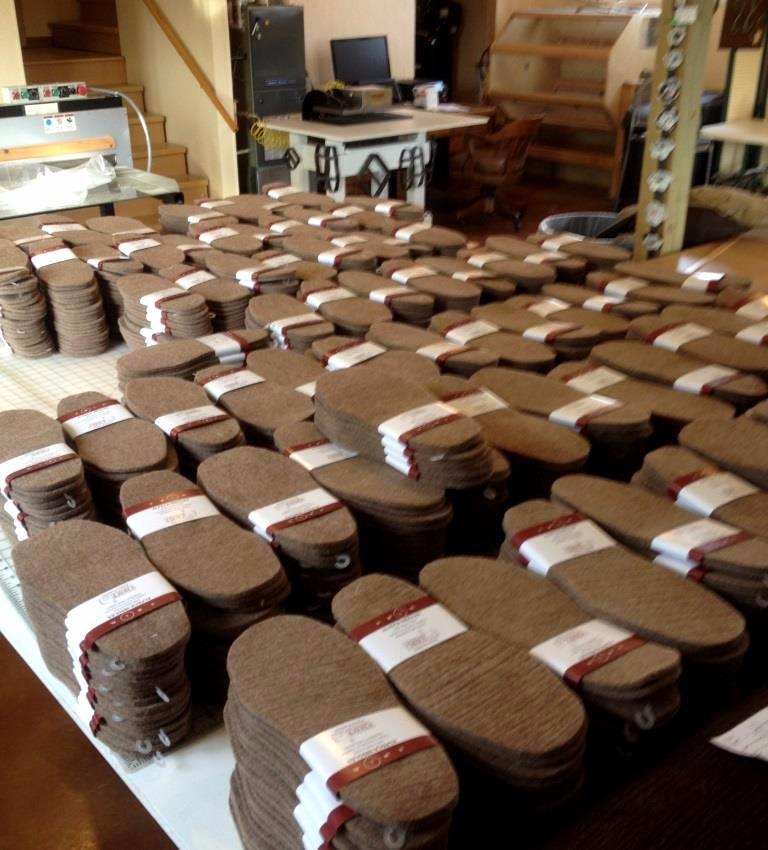 A pair of American Choice Alpaca Foot Warmers, soft and thick insoles made from 100% USA alpaca fiber, designed for warmth and comfort in shoes and boots.