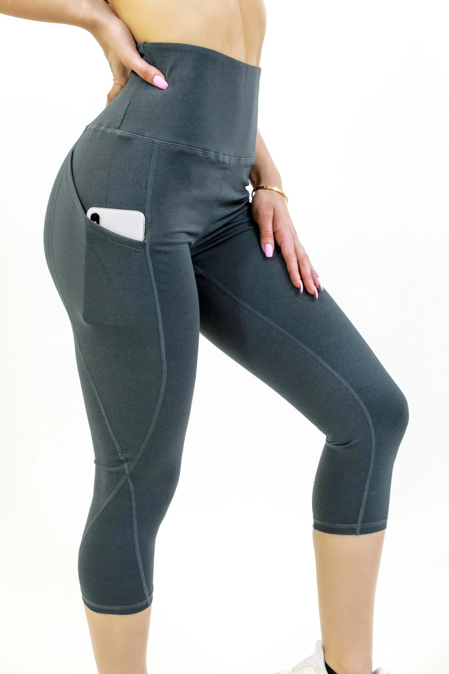 Seajoy Athletic High-Waisted Capri Leggings in black with hip pockets, showcasing a smooth waistband and stretchy fabric, ideal for workouts.