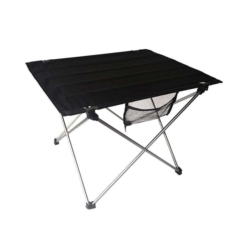 High Quality Portable Outdoor Camping Small Folding Table set up in a natural outdoor setting, showcasing its lightweight aluminum frame and waterproof surface.