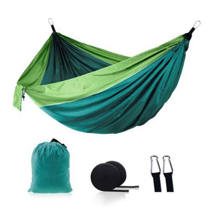A vibrant outdoor camping hammock swing set in purple, grey, and blue, showcasing its foldable design and included accessories.