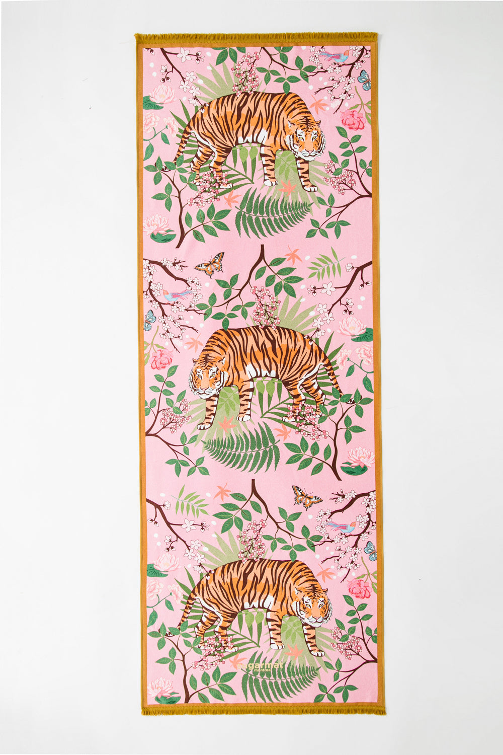 The Striped Charmer yoga towel featuring a majestic feline design surrounded by cherry blossoms, with cute tassels on the edges.