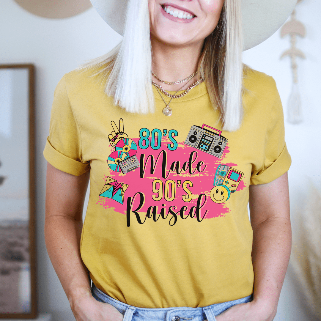A stylish 80's Made 90's Raised Tee in vibrant colors, showcasing its soft cotton fabric and durable double stitching.
