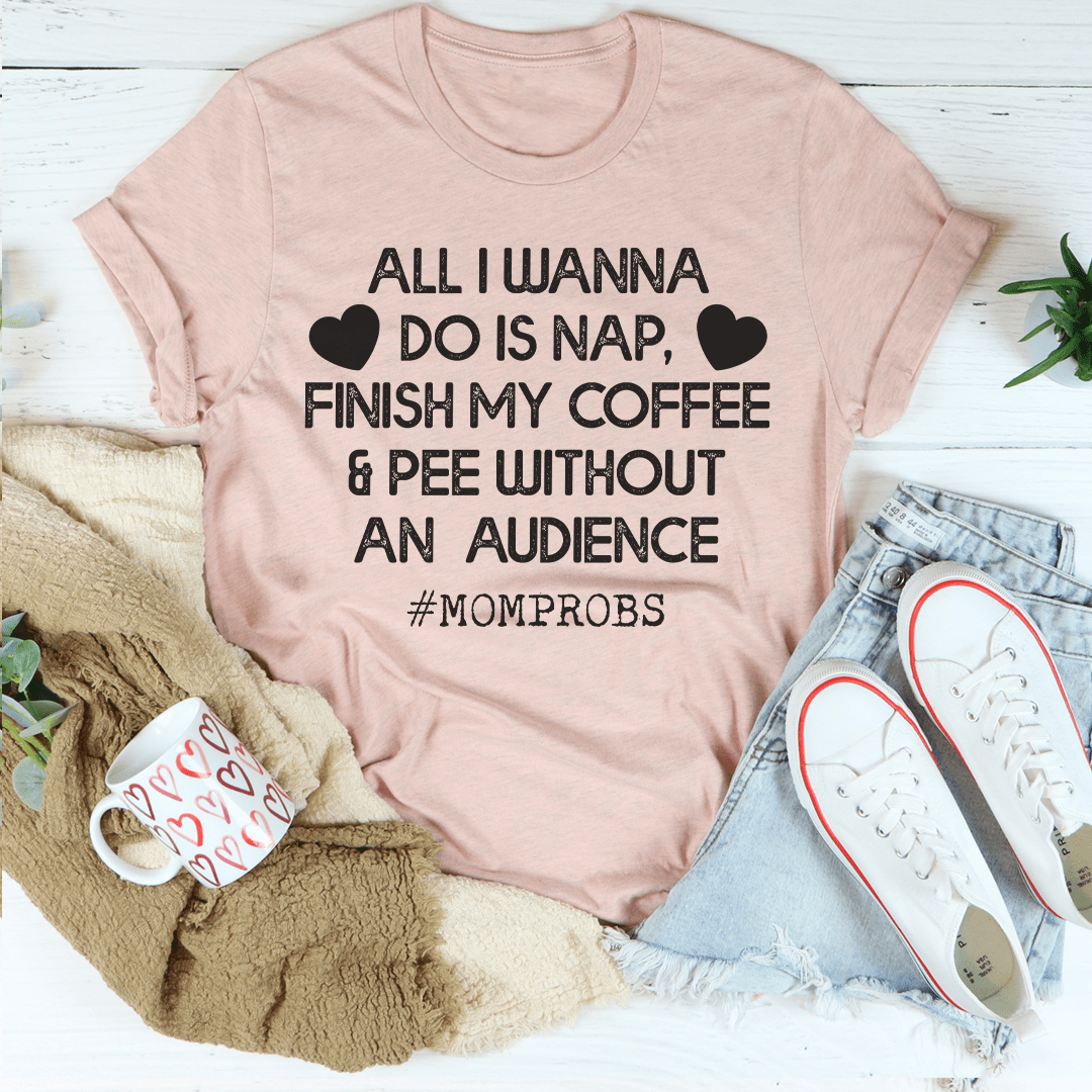 A comfortable mom t-shirt featuring the phrase 'All I Wanna Do Is Nap & Finish My Coffee' in a stylish design.