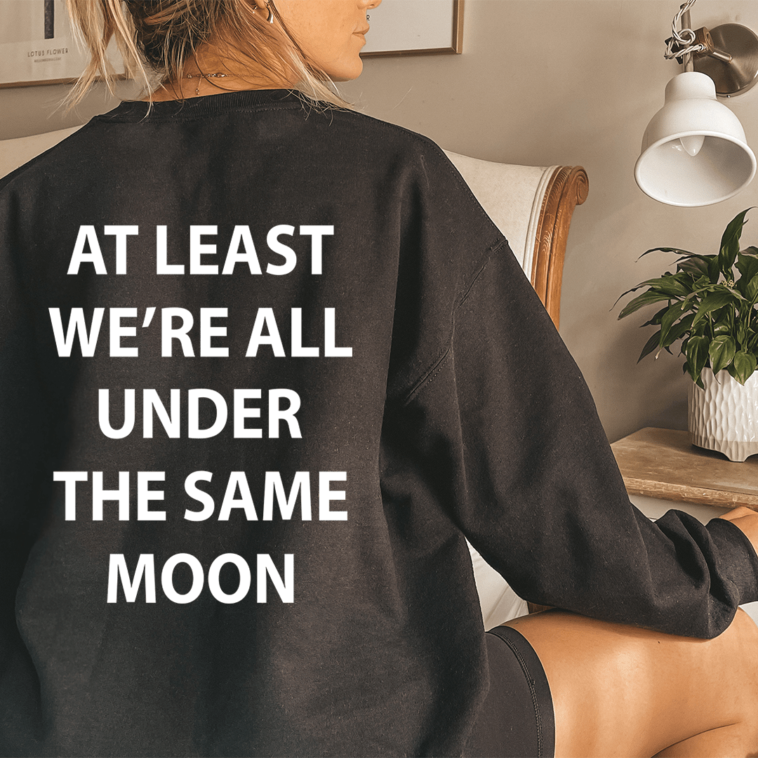 Cozy 'At Least We're All Under The Same Moon' sweats featuring unique artistic designs, made from cotton/poly fleece blend.