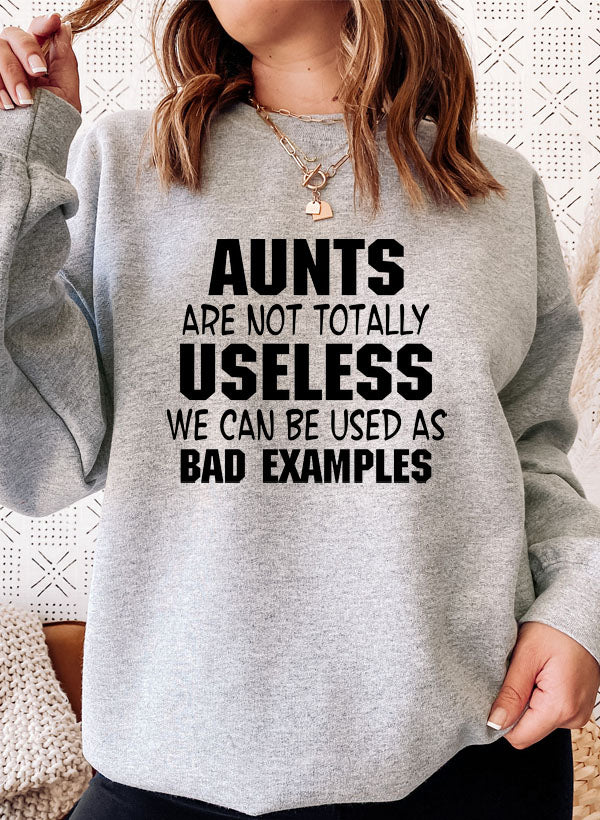 A cozy Aunts Are Not Totally Useless Sweat Shirt featuring a humorous design, made from a soft cotton/poly fleece blend.