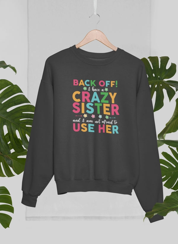 Cozy Back Off I Have A Crazy Sister Sweat Shirt in cotton/poly fleece blend, featuring adjustable banded cuffs and a fun design.