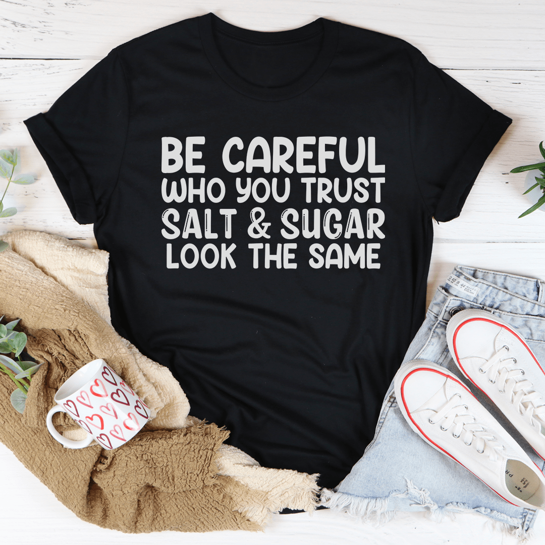 Be Careful Who You Trust Tee in various colors, showcasing its soft fabric and durable stitching.
