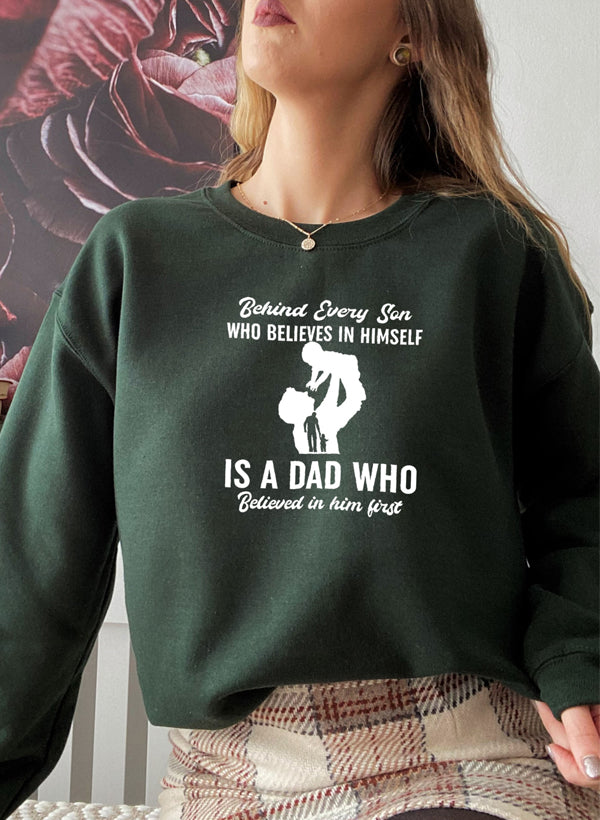A stylish sweatshirt featuring the phrase 'Behind Every Son Who Believes In Himself', made from a cozy cotton/poly fleece blend.