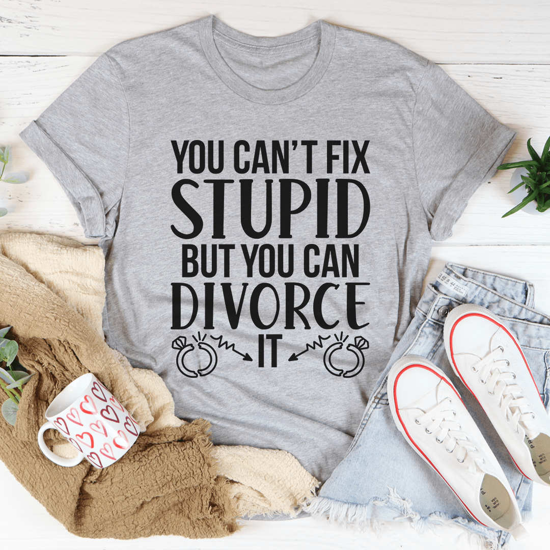 A humorous Can't Fix Stupid But You Can Divorce T-Shirt displayed on a mannequin, showcasing its soft cotton fabric and double-stitched neckline.