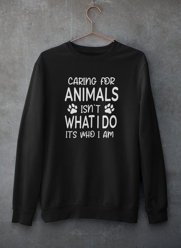 A cozy sweatshirt featuring the phrase 'Caring for Animals Isn't What I Do It's Who I Am', perfect for animal lovers.