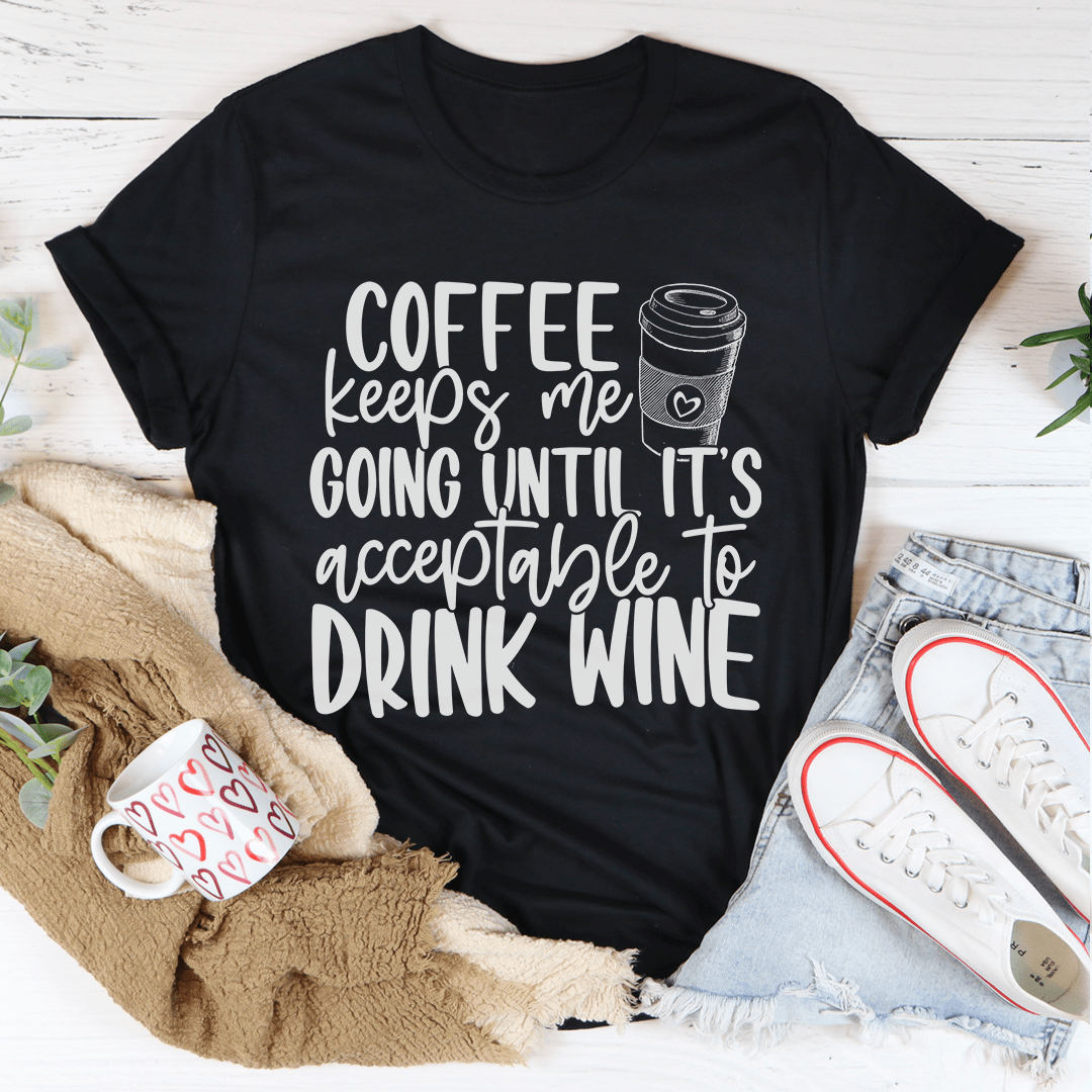 Coffee Keeps Me Going Until It's Acceptable To Drink Wine T-Shirt displayed on a mannequin, showcasing its soft fabric and humorous design.
