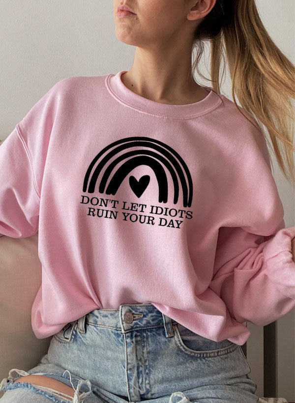 A cozy 'Dont Let Idiots Ruin Your Day' Sweat Shirt featuring a unique design by top artists, made from a warm cotton/poly fleece blend.