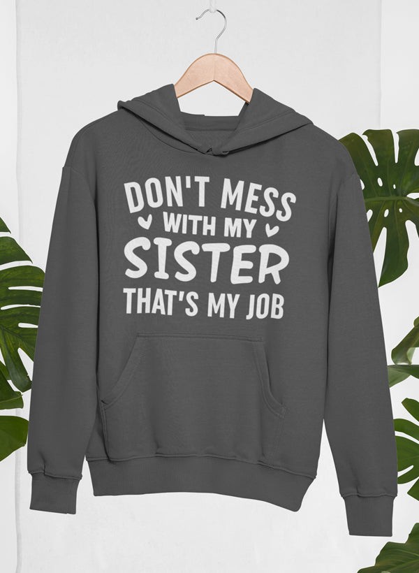 A cozy hoodie featuring the phrase 'Don't Mess With My Sister That's My Job' designed for comfort and style.