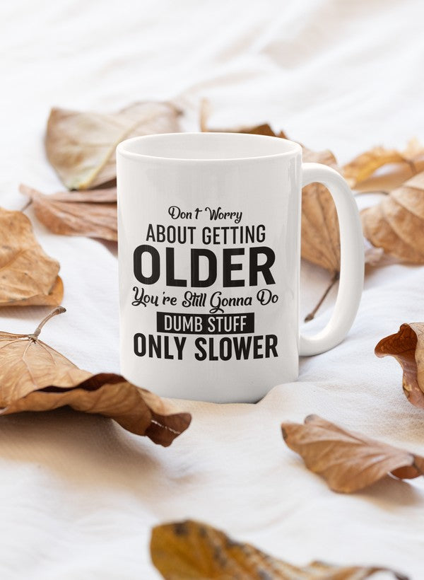A stylish 11oz ceramic mug with a glossy finish featuring the phrase 'Don't Worry About Getting Older' and a sturdy handle.