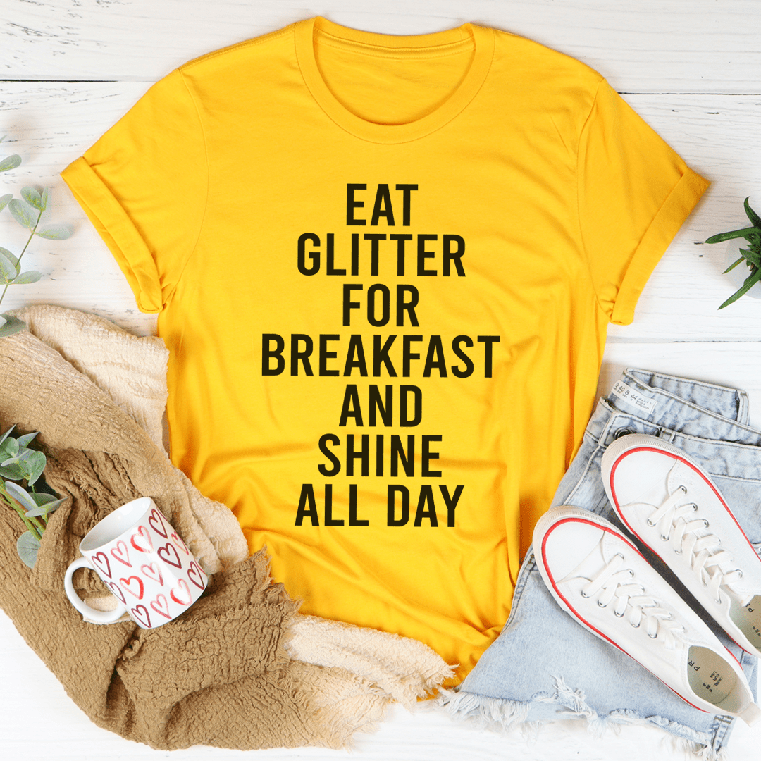 Eat Glitter For Breakfast And Shine All Day T-Shirt in vibrant colors, showcasing its soft cotton fabric and double-stitched neckline.