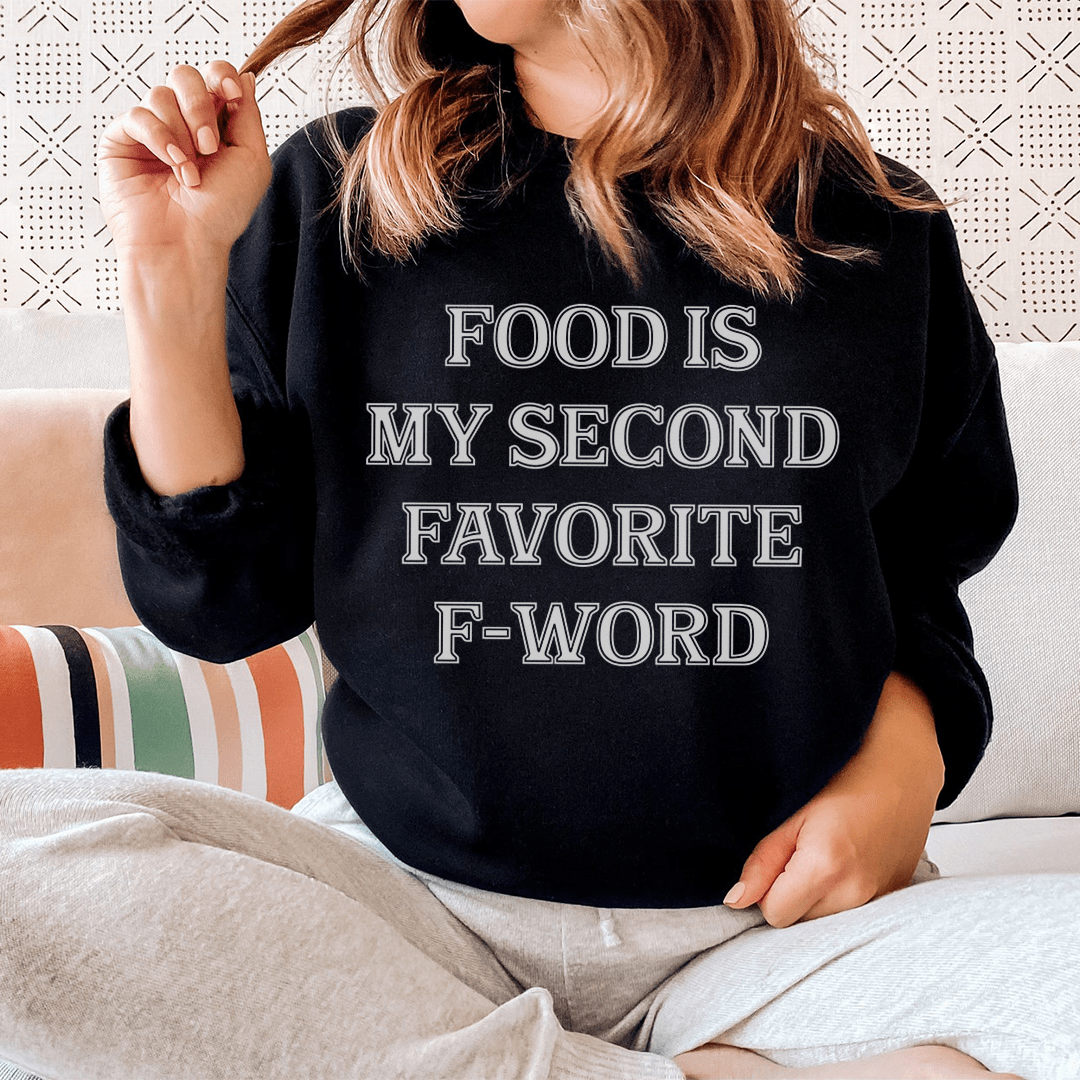 Cozy sweatshirt featuring the phrase 'Food Is My Second Favorite F-Word' designed by top artists, showcasing a warm fleece lining and adjustable cuffs.