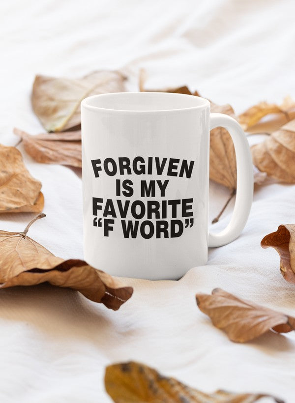 A stylish 11oz ceramic mug with the phrase 'Forgiven Is My Favorite F Word' printed in a fun design, featuring a glossy finish and sturdy handle.