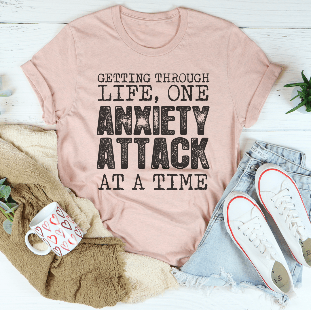 A comfortable t-shirt featuring the phrase 'Getting Through Life One Anxiety Attack At A Time', made from soft ring-spun cotton with durable stitching.