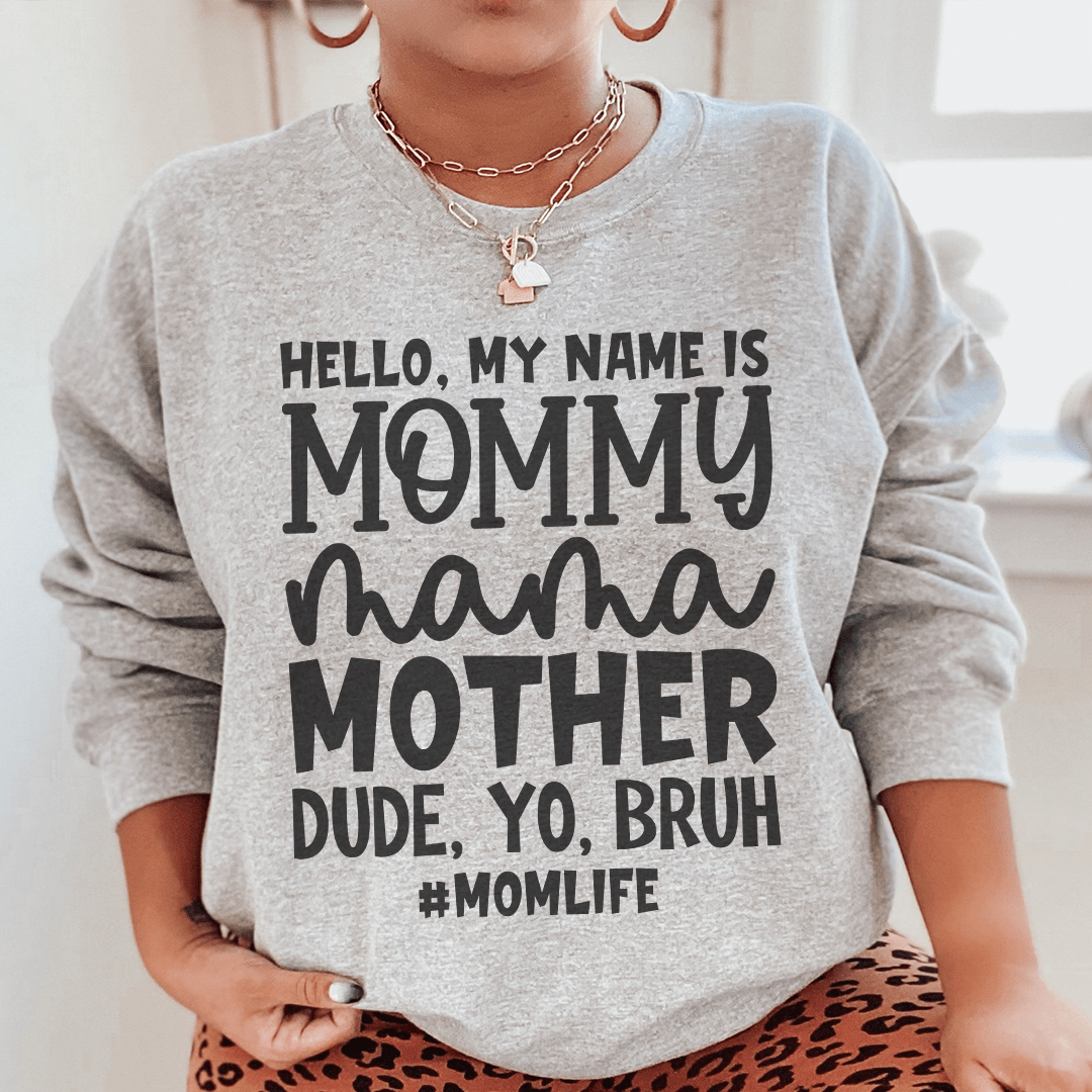 A cozy hoodie featuring the phrase 'Hello My Name Is Mommy', designed by top artists, made from a cotton/poly fleece blend.