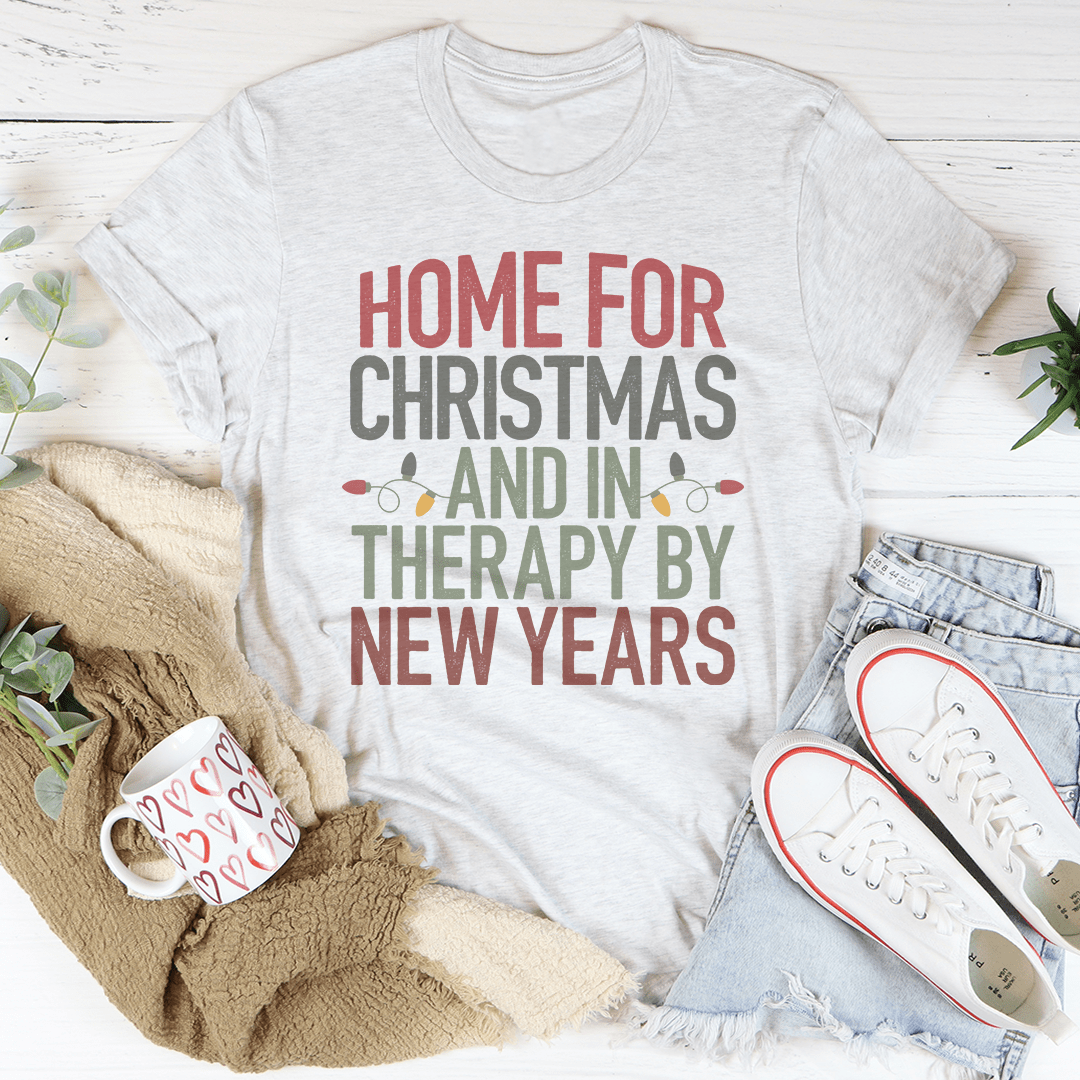 A cozy, festive t-shirt featuring the phrase 'Home For Christmas And In Therapy By New Years' printed in vibrant colors on soft cotton fabric.