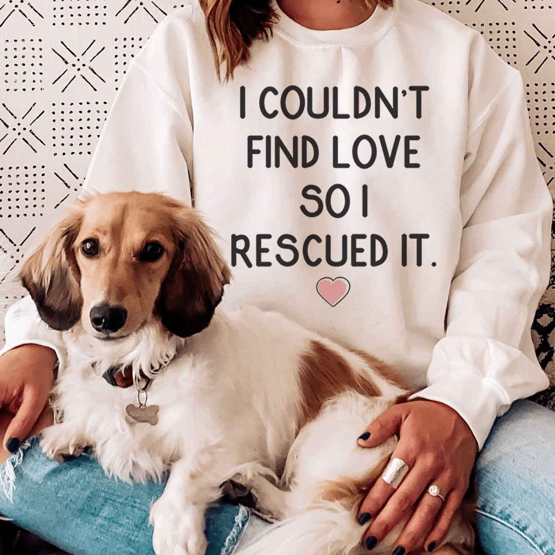 A cozy hoodie featuring the phrase 'I Couldn't Find Love So I Rescued It', designed by top artists, showcasing a unique and stylish design.