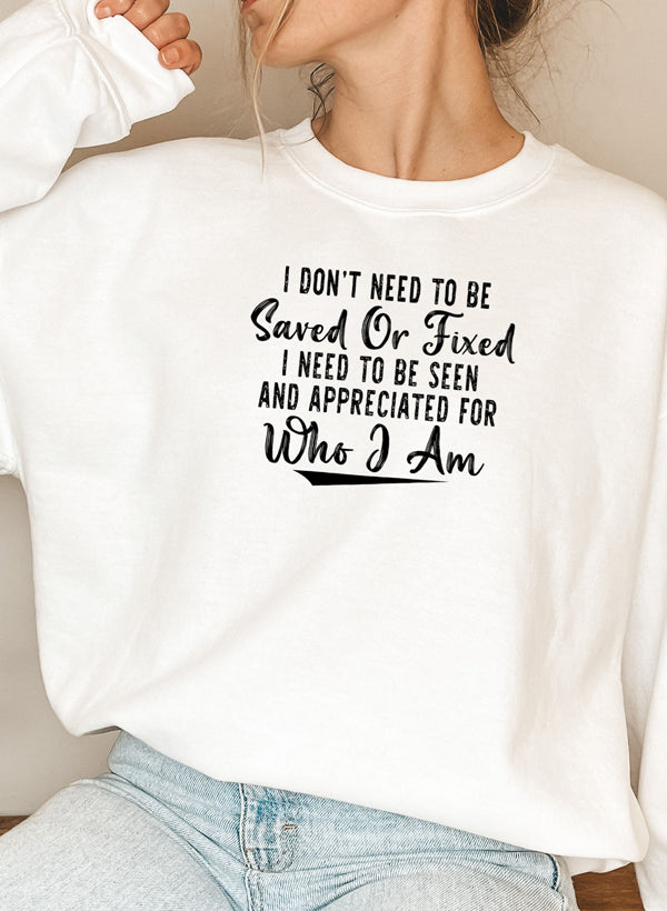A cozy sweatshirt featuring the phrase 'I Don't Need To Be Saved Or Fixed', made from cotton/poly fleece blend, perfect for casual wear.