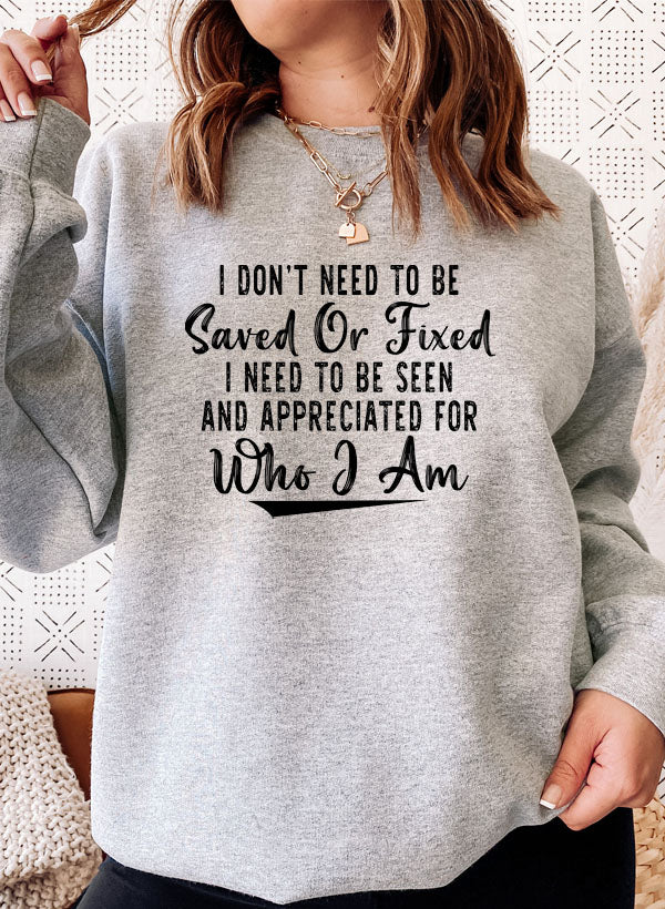 A cozy sweatshirt featuring the phrase 'I Don't Need To Be Saved Or Fixed', made from cotton/poly fleece blend, perfect for casual wear.