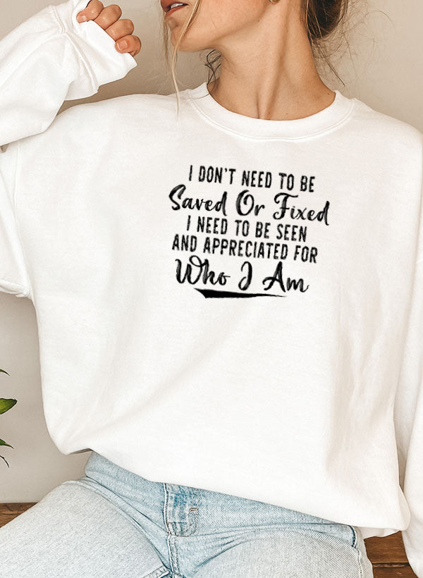A cozy sweatshirt featuring the phrase 'I Don't Need To Be Saved Or Fixed', made from cotton/poly fleece blend, perfect for casual wear.