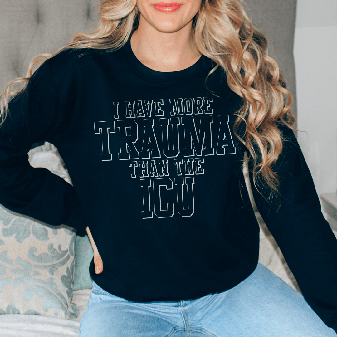 Cozy 'I Have More Than Trauma Than The ICU' sweats featuring a cotton/poly fleece blend, designed by top artists for comfort and style.