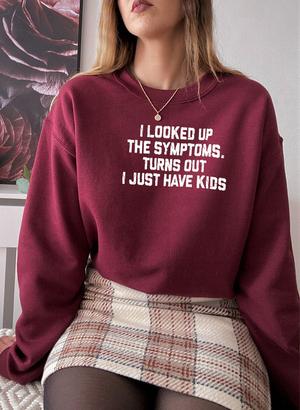 Cozy sweatshirt featuring the phrase 'I Looked Up My Symptoms Turns Out I Just Have Kids', made from soft cotton/poly fleece blend.