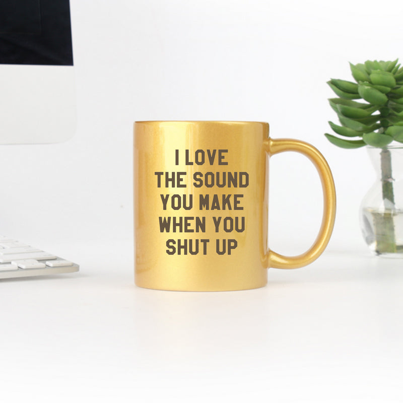 Ceramic mug with gold and silver metallic coating featuring humorous text design.