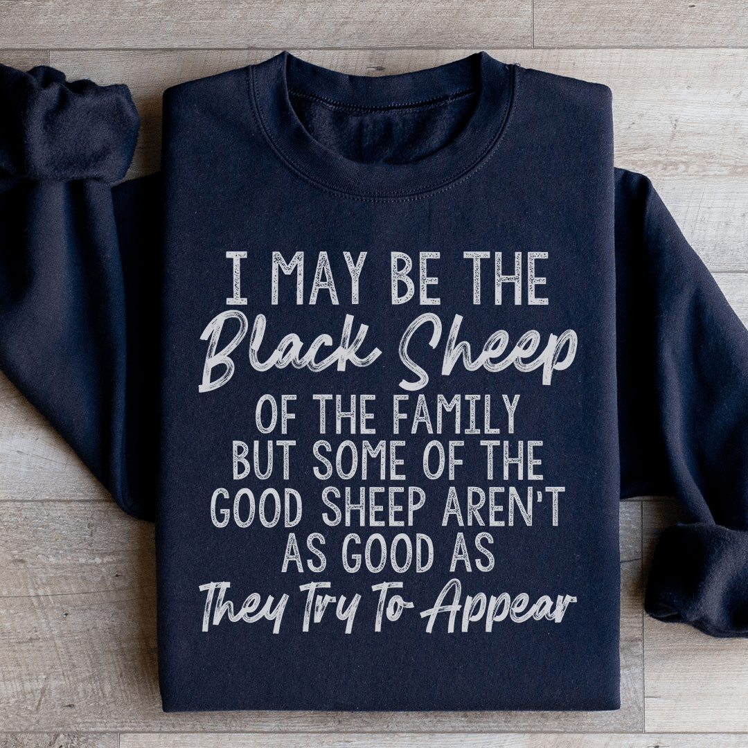 A cozy black sweatshirt featuring the phrase 'I May Be The Black Sheep Of The Family', designed by top artists, perfect for casual wear.