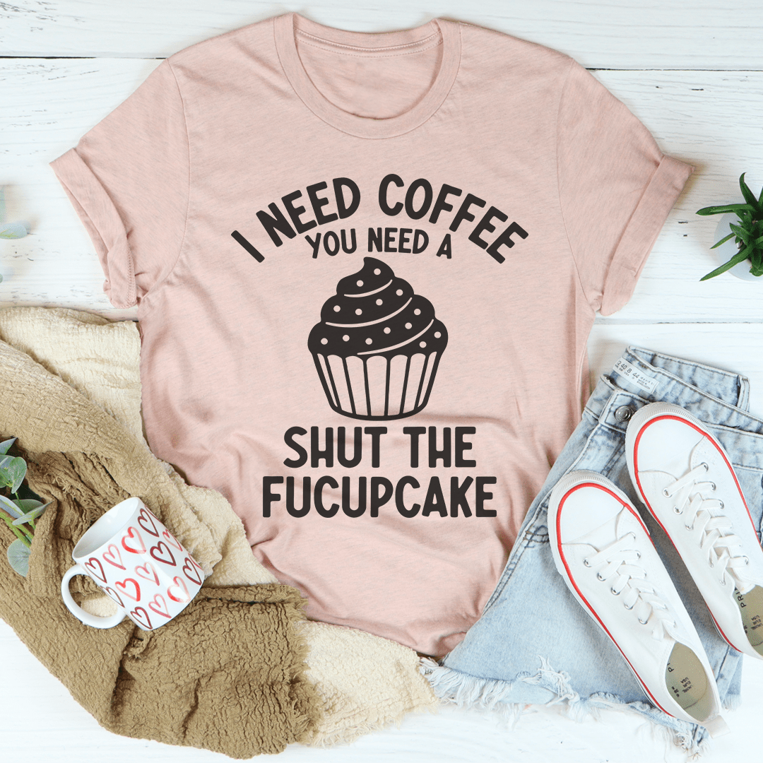 A humorous t-shirt featuring the phrase 'I Need Coffee You Need A Shut The Fucupcake', made from soft ring-spun cotton.