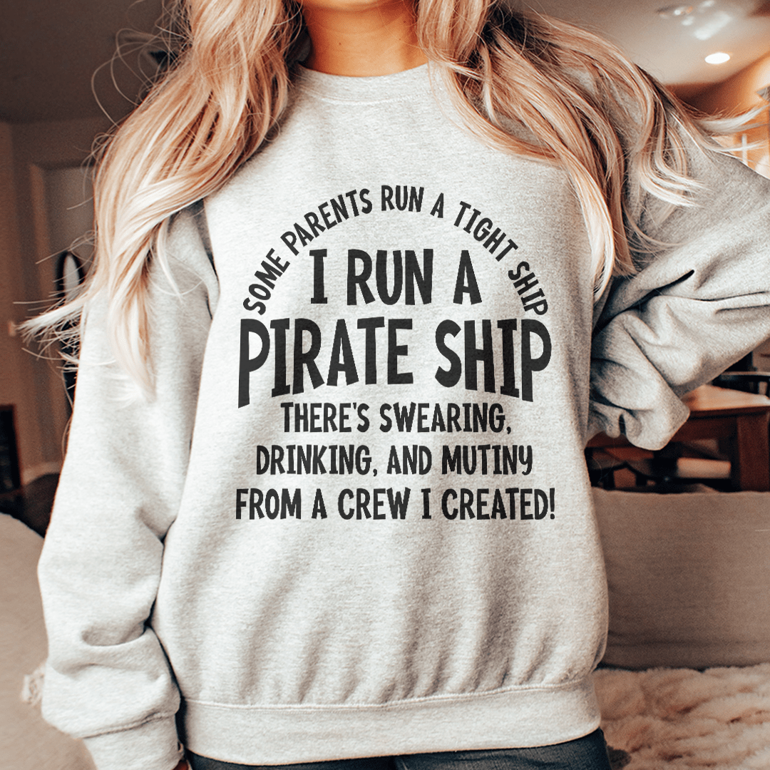 A cozy I Run A Pirate Ship hoodie featuring a unique pirate ship design, made from a soft cotton/poly fleece blend.