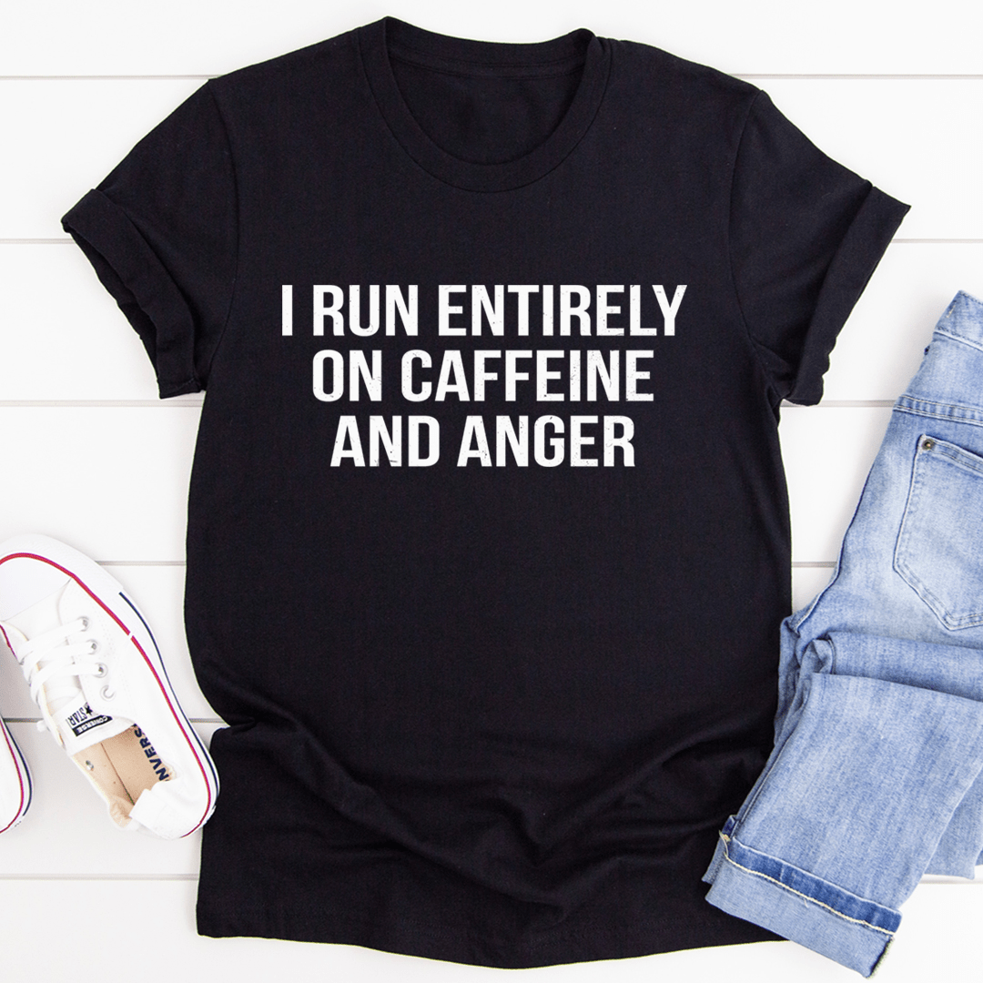 A stylish black t-shirt with the phrase 'I Run Entirely On Caffeine And Anger' printed in bold white letters, showcasing a casual and humorous design.